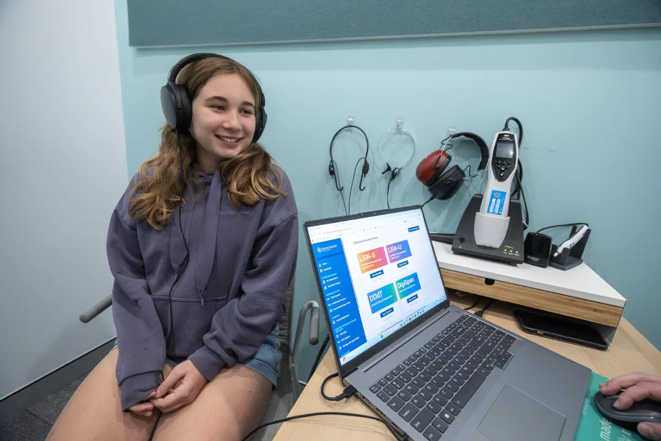 A child with headphones takes a hearing test.