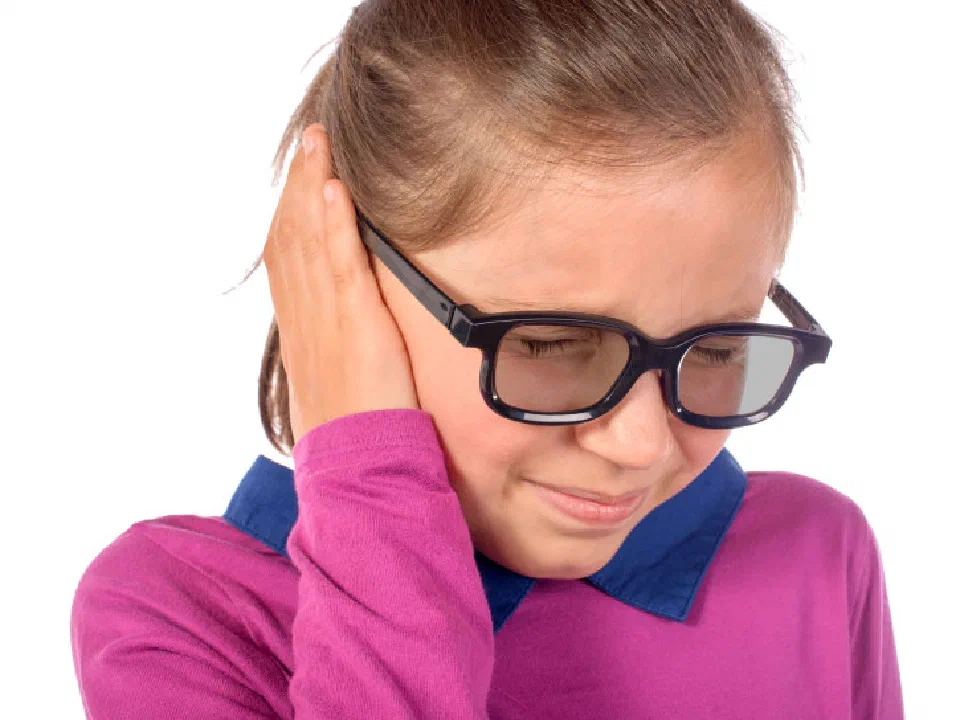 Young girl with glasses hold her hand over her ear in pain.