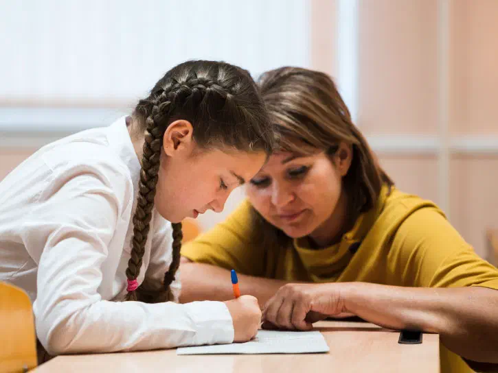 Teacher conducting a compulsory phonics test with a student