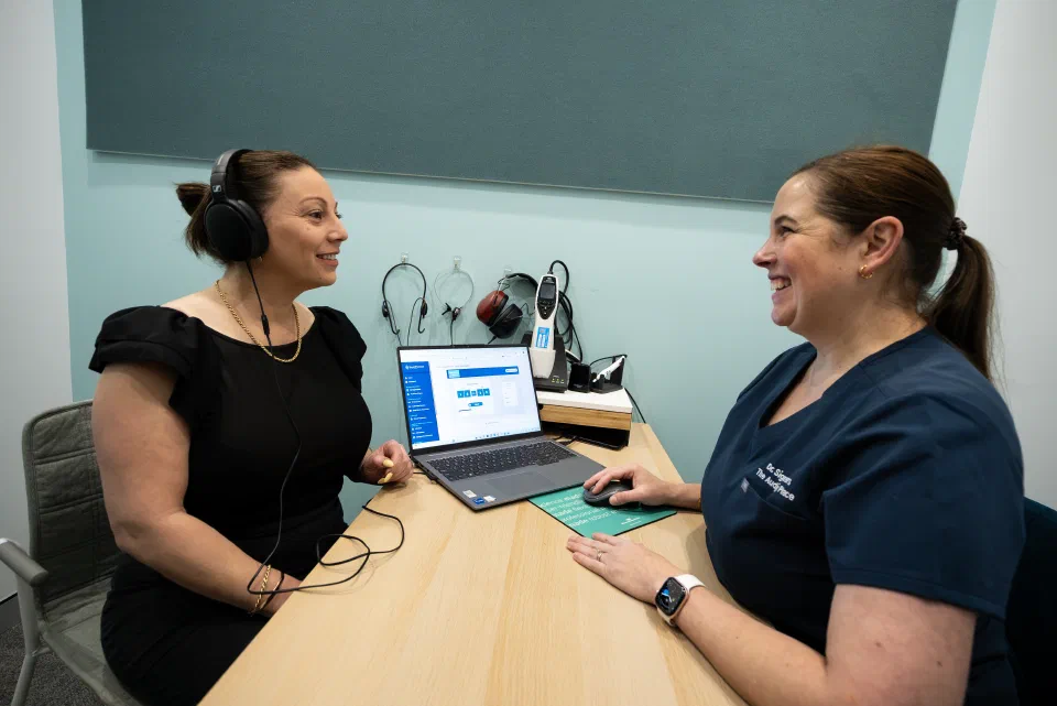 An audiologist and woman take the DDdt Test.